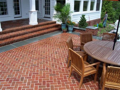 Brick pavers in a herringbone pattern set with a flamed bluestone