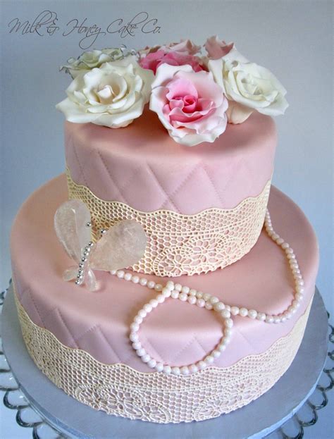 a tropical bridal shower cake with a gold tie