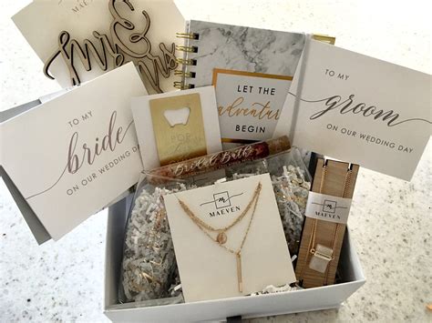 Bridal subscription box. Price: $59.99Shop on: Etsy. White and gold bridal engagement gift is a gift box that any bride-to-be will treasure forever. It holds a diamond pen, notebook, coffee Mug, candle with match matches, lip balm, personalized congratulations card, and bride T-Shirt that will make a perfect addition to any bridal shower. 
