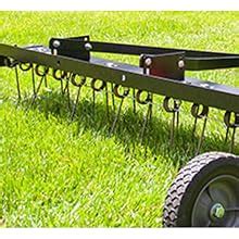 Brinly dethatcher.  Two rows of flexible tine tips comb the lawn, extracting thatch a...