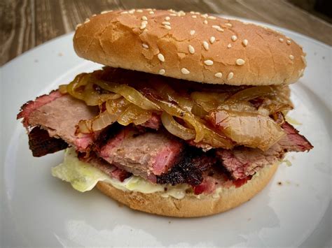 Brisket burgers. Generously oil the grill and rake the coals to one end for direct and indirect heat. Place the bacon on the indirect side of the grill, shut the lid and cook for about 4 minutes each side or until crispy. Set aside in a warm place. In a small bowl, combine the salt, garlic powder, smoked paprika and coarse ground pepper. 
