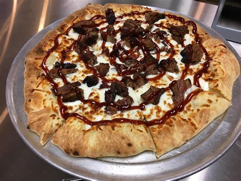 Brisket pizza. In a saucepan over medium heat, combine barbecue sauce, silan, wine, paprika, and liquid smoke. Bring to a boil and simmer for five minutes. Pour sauce over meat. Tightly cover baking pan and bake for six hours. (If using a raw brisket, bake for 12 hours at 200 degrees Fahrenheit.) When cool enough to handle, shred meat using two forks. 