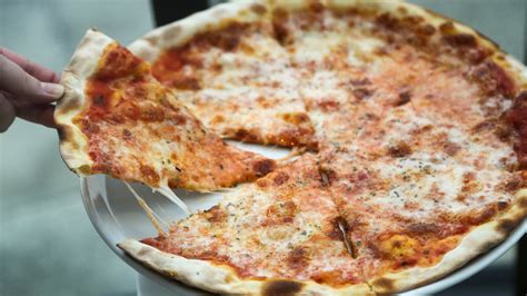 Brooklyn style crust. A Brooklyn-style pizza is characterized by a thin crust that is crunchy on the outside and soft on the inside, with tomato sauce and mozzarella cheese made from half skim and half ... 