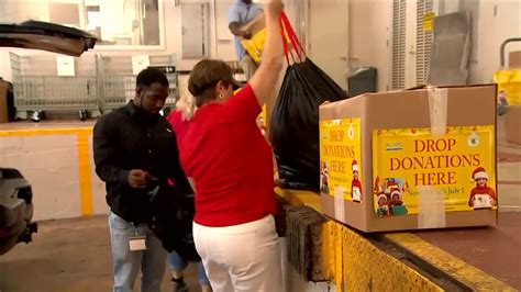 Broward officials fill boxes with donated items ahead of county’s Christmas in July deliveries