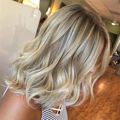 This long blonde balayage straight hair with edgy razor-cut ends and gradual transition from light brown roots to icy blonde is a great way to go. However, bear it in mind that your hair color hue has to hang together with your skin undertone. No other restrictions exist concerning this platinum balayage..