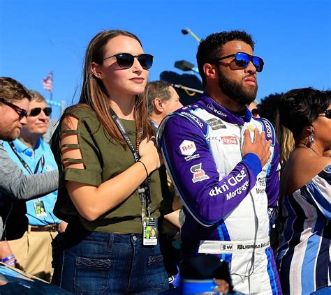 FORT WORTH, TEXAS – JUNE 13: Bubba Wallace, driver of the #23 Door Dash Toyota, poses for a photo on the grid with his girlfriend, Amanda Carter prior to the NASCAR All-Star Open at Texas Motor .... 