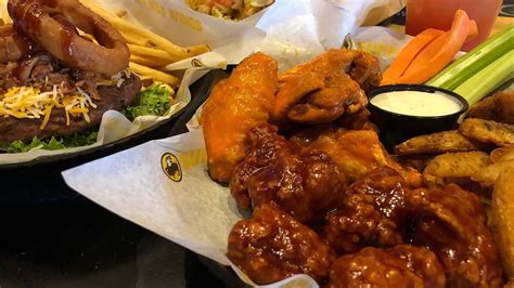 Buffalo wild wings bossier. IT ALL STARTED 35 YEARS AGO WITH TWO GUYS DRIVEN BY HUNGERThe year was 1982. Jim Disbrow and Scott Lowery had recently moved to Ohio from Buffalo, New York. All was fine until one day when the two were craving wings. Not just ordinary wings, but authentic Buffalo, New York-style chicken wings. With none to be found nearby, Jim … 