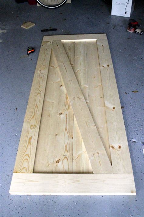 Build a door. First, cut the width of the plank down approximately 1", slimming it down to a more practical width for opening and closing the door with ease. Next, measure, mark and cut ledge, mitering two corners at a 45 degree angle. Tip: The angled cuts along the edges will keep the ledge from interfering with the opening and closing of the door. 