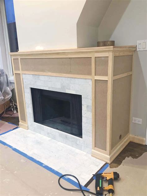 Building a fireplace. After they’re edge-glued and sanded, attach the mantel top (E) to the top of the mantel box (H). Be sure it’s flush with the back of the box, as well as a 1-1/2 in. overhang on both ends and along the front of the mantel. Secure it with wood glue and 1-1/4-in. screws from inside the mantel box. Family Handyman. 