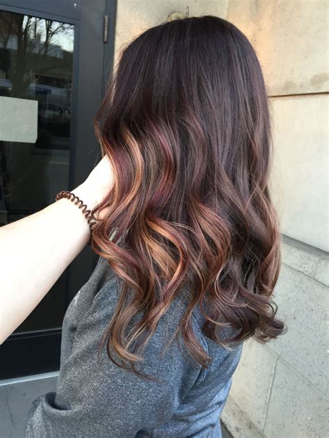 Burgundy hair with caramel highlights is a look that is rich, warm, 