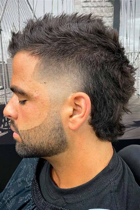 The burst fade mullet blends two iconic styles: the mullet’s business-in-the-front, party-in-the-back ethos with the seamless gradient of a burst fade. Rising to popularity in the 1980s, the mullet has seen various transformations, with the burst fade edging its way in more recently to give it a modern twist.. 