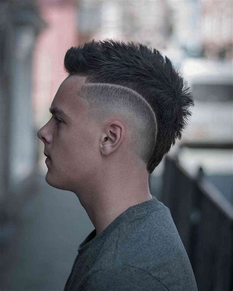 The high fade into the mohawk crest gives the style a modern edge. 
