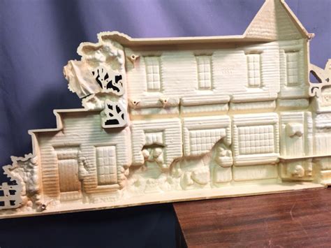 This vintage 1970s wall hanging from Burwood Products Co. features a charming 3D farm barn scene. Measuring 46 inches long, it is a great addition to any collection of vintage, retro, or mid-century items. The piece is an original and was created in the United States, with no modifications or handmade elements. The wall art is perfect for adding a touch of nostalgic charm to any room.