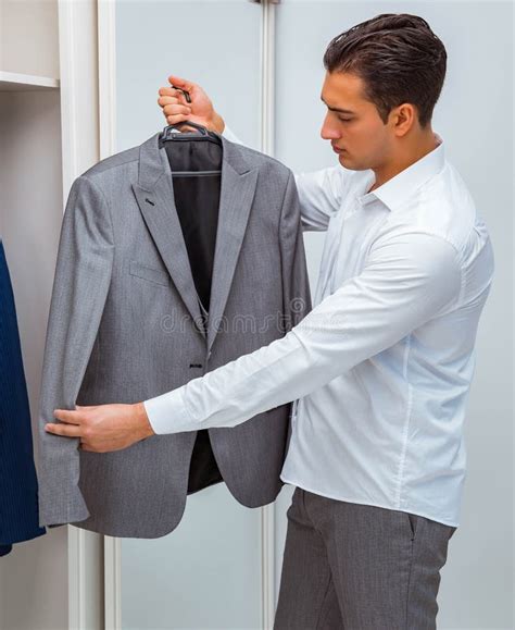 Businessman dressing. To dress business formally, wear tailored, conservative clothing such as suits, dress shirts, blouses, slacks, and pencil skirts. Some appropriate business casual clothing includes polo-style shirts, oxford-style shirts, blouses, mid-length skirts, and brown, black, and blue pants. Wear closed-toe shoes like flats, heels, or dress shoes. 