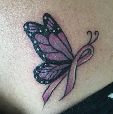 Butterfly and breast cancer tattoos. 2) Wide Black and White Butterfly on Forearm. Image source. A skin color contrast tattoo design which is bold and clear to see on the forearm. This butterfly tattoo says a lot about the individual strength of the person wearing it. The forearm is a tattoo site that proves confidence when it is allowed to be inked. 
