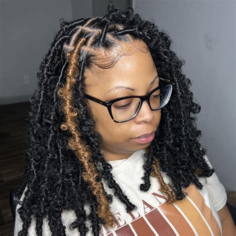 Step 2: Crochet the Water Wave Hair Into Braids. First, fluff and prep your water wave hair to prime it for your locs. This will give your locs more volume and texture to really nail that butterfly loc look. Take 2 pieces of your water wave hair and use your fingers to gently separate the curls a bit.. 