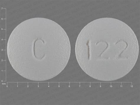 C 122 pill. The adult daily dosage of amantadine hydrochloride capsules is 200 mg; two 100 mg capsules as a single daily dose. The daily dosage may be split into one capsule of 100 mg twice a day. If central nervous system effects develop in once-a-day dosage, a split dosage schedule may reduce such complaints. 