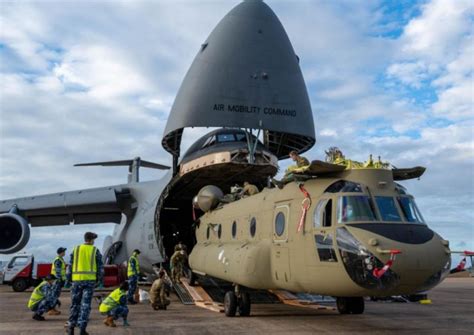 C-5 Galaxy cargo plane carries Chinook helicopters from U