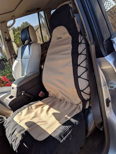 This Bass Pro Shops seat cover provides a great look with the durable protection of heavy-duty, 600-denier polyester. The rugged fabric beads and repels light surface liquid to deliver long-lasting protection for the seats in your vehicle. With an improved design, this cover fits a wide range of bucket seats and keeps the cover tight to the seat.