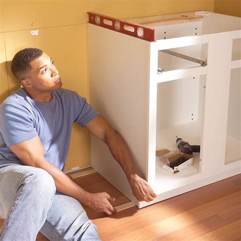 Cabinet installation. STEP 2: Mark a level line 19.5 inches above the base cabinet line to represent the bottom of the upper cabinets. If you are installing cabinets above the base cabinets, then the next step is ... 