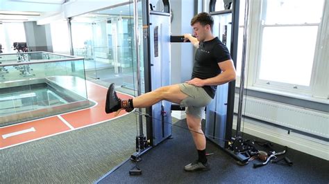 Cable leg extension. The standing cable hip extension is an excellent isolation movement for targeting the glute and hamstring muscles. The exercise is performed using a cable machine, which provides resistance through a cable attached to a weight stack. ... Begin by attaching an ankle strap to the bottom of the cable machine. Place your working leg in front and ... 