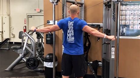 Cable rear delt fly. Hold a pair of dumbbells, lean forward, and let your arms hang towards the floor. With almost straight arms (just a slight bend at the elbow), slowly lift the dumbbells by raising your arms out to the sides. Reverse the movement and lower the dumbbells back to the starting position. 4. Reverse Machine Fly. 