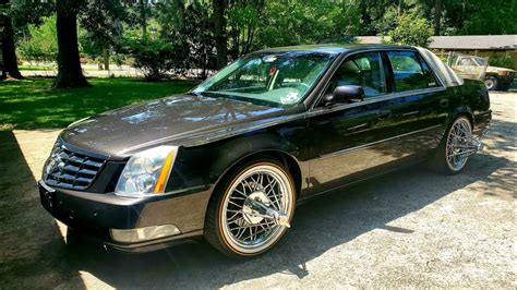 Cadillac dts on 20s. DTS on Swangas. 2011 Cadillac DTS sitting on 20 inch Texas Wire Wheels known as “Swangas”. Save. Save. More like this. several blue cars parked in a parking lot. 