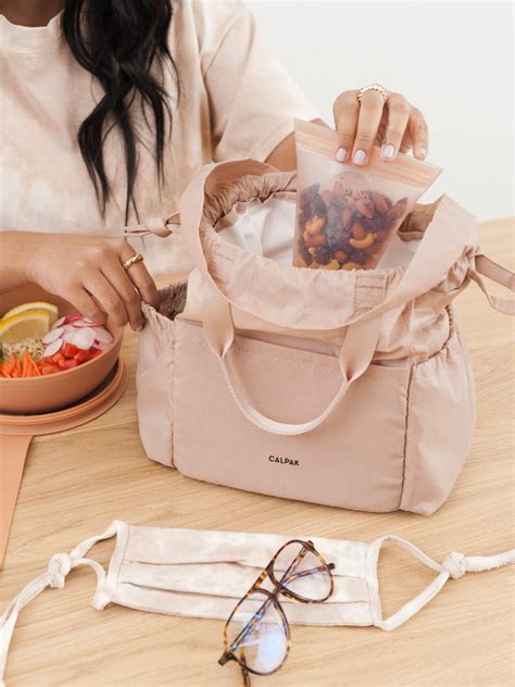 Calpak lunch bag. Calpak. To buy: calpaktravel.com, $58. Made with a lightweight, stain-resistant material, the Calpak Luka Belt Bag comes in four classic colors: oatmeal, matte black, chocolate, and rose quartz ... 