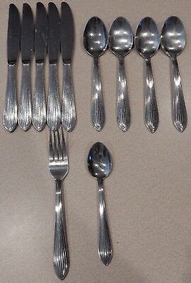 Cambridge Brand Stainless Steel Flatware - 36 pieces in all This Tableware is marked Cambridge 18-8 Korea on the back. It is a stainless steel silverware. A very sleek contemporary styling table service in the Sutton - Glossy pattern. Set Includes: 8 Dinner Knifes 7 Dinner Forks 8 Salad Forks 4