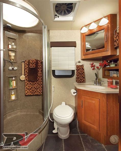 The bathroom boasts an RV toilet, a single-basin sink with a mirrored vanity above, and a walk-in shower with a raised skylight. The corner design of the shower is a great feature because it provides a little more elbow room than other RV showers. The interior also features a 10 cubic-foot refrigerator for perishable food storage.. 