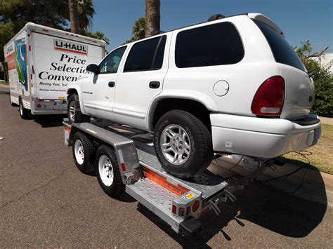 A quick Google search for "2014 Rav4 towing capacity" tells me its 1500lbs. Check your owners manual to be sure. The U-Haul page here here says you need a minimum 2000lbs capacity hitch, so they shouldn't rent you that trailer. Even if they did, the trailer empty weighs 850lbs, so you couldn't put hardly anything in it. .