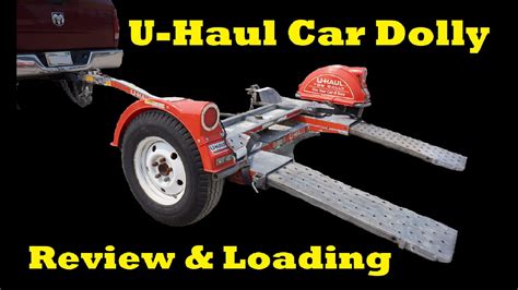 Unlike a tow dolly, an auto transport puts the entire vehicle on the trailer. This permits the car trailer to handle a larger vehicle. U-Haul’s auto transport is built to handle a max load of 5,290 lbs. The dual-axle trailer lets you forget all about whether your car is four- or two-wheel drive because it does all the heavy lifting. . 