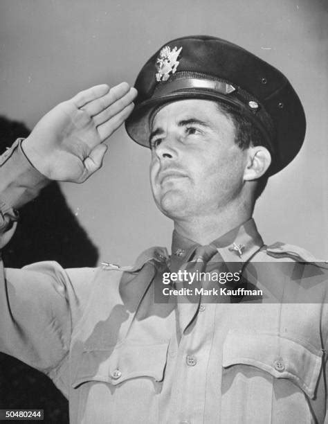 Capt. Hewitt T. Wheless of the US Army saluting the flag.