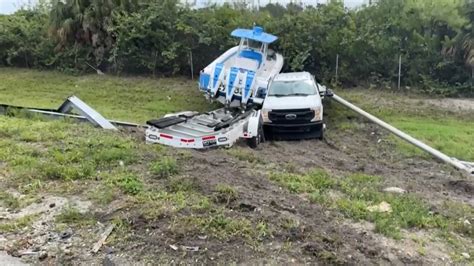 Car crash sends boat on trailer off the road in Fort Lauderdale