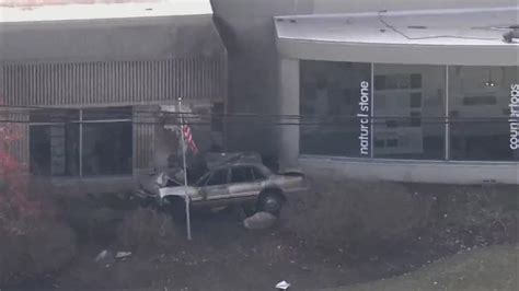 Car crashes into building, catches fire in Northbrook