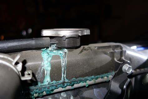 Car leaking coolant. Inspect the radiator seams for splits, also the catch tank and its pipe. Watch for leaks at the water-pump bearings and from the pump gasket. Check the thermostat housing for cracks, and the housing gasket for leaks. A rising temperature gauge , a pool of coolant beneath the car and a drop in the radiator level are signs of a leak. 