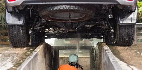 2. Cleaning your undercarriage with a pressure washer and bru
