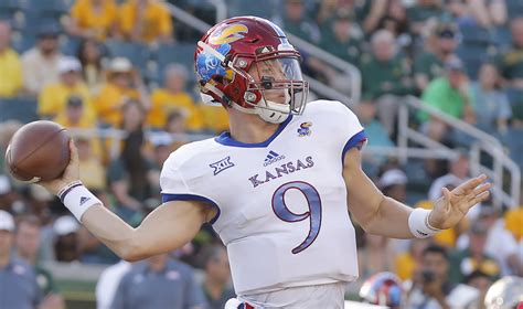 Kansas quarterback Carter Stanley (9) heaves a deep pass for a touchdown to wide receiver Chase Harrell (3) during the fourth quarter on Saturday, Sept. 3, 2016 at Memorial Stadium.
