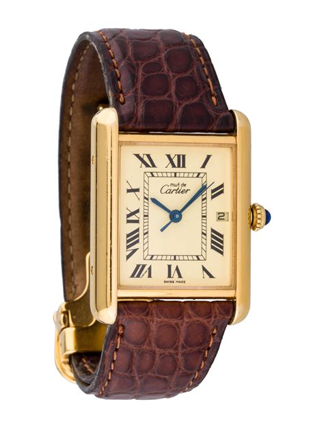Cartier tank watch. Tank Must watch, extra-large model, Manufacture mechanical movement with automatic winding, caliber. Steel case, beaded crown set with a synthetic cabochon-shaped spinel, silvered flinqué dial, blued-steel sword-shaped hands, interchangeable black grained calfskin strap, interchangeable steel deployant buckle, calendar aperture at 6 o'clock. 