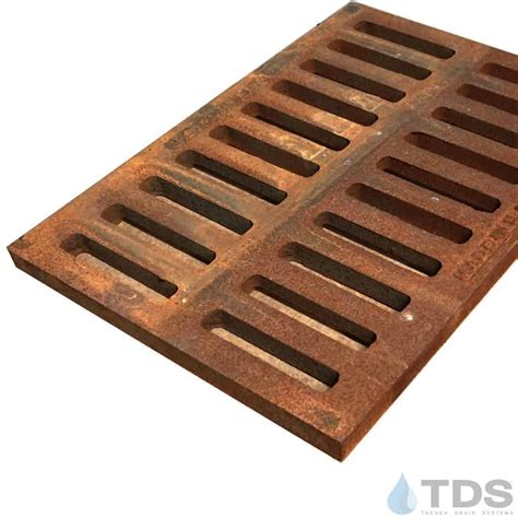 Cast iron grate. Cast iron grates are common and have been around for centuries. When engineers started asking for higher strength trench drain grates manufacturers started using ductile iron for trench grates. Cast iron grates are strong and suitable for road drainage grates, driveway drainage grates, and other heavy duty trench drain grate applications. ... 