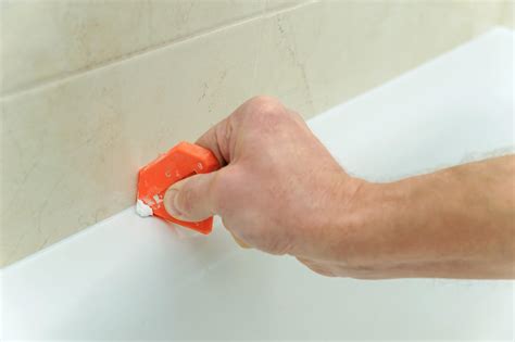 Caulk in bathtub. For more home improvement tips visit https://www.homerepairtutor.com/👍🏼http://www.homerepairtutor.com/how-to-caulk-a-bathtub/Do you need to learn how to ca... 