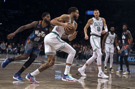 Celtics outlast Nets 124-114 behind Tatum and Holiday’s double-doubles