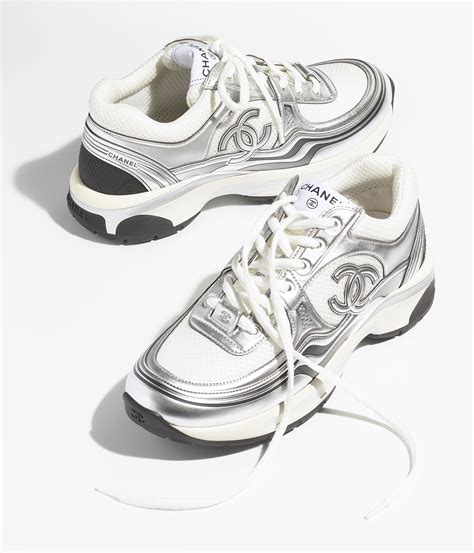 Chanel silver sneakers. View this item and discover similar for sale at 1stDibs - Add a little logo to your ath-leisure looks with our Chanel silver sneakers! Shiny silver leather construction with glossy black patent toe cap and CC 