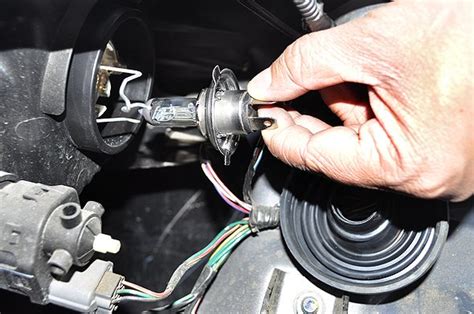 Change headlight. 3. Remove the rubber gasket by pulling the tab on the bottom. 4. There is a wire bail holding the headlamp in the socket. Move it by pushing the handle toward the front of the vehicle, then pull it up to disengage. (Much like a safety pin.) 5. Pull the headlight directly backwards out of the socket. 6. 