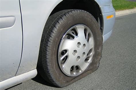 Changing a flat tire. Safely set the tire down and roll it aside. Mount the new or replacement tire in reverse order to the removal of the old tire, and hand tighten the lug nuts. Rotate the lever of the jack counterclockwise to lower the tire to the ground. Remove the jack, and use your lug nut wrench to fully tighten the lug nuts. 