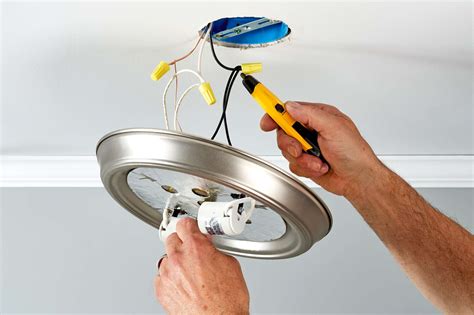Changing out a light fixture. Remove the light bulb cover and bulbs from the fixture. Unscrew the screws or nuts holding the fixture base to the ceiling box. Lower the fixture base and remove the electrical tape or wire nuts from the black (hot) wire, white (neutral) wire, and, if present, green (ground) wire. Attach the wires from the new fixture … 