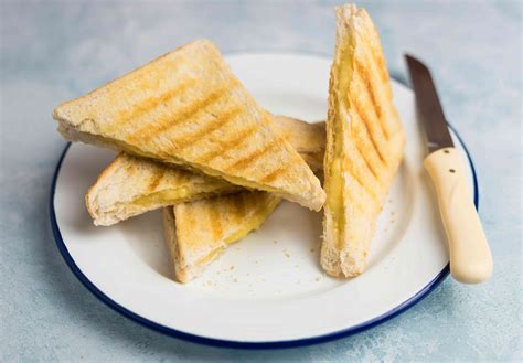 Cheese toastie. Get one of your buttered slices of bread and lay it butter side down in the frying pan and arrange the cheese ontop of it. Next, get the other slice of bread ... 