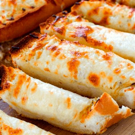 Cheesybread. In a small bowl, combine the melted butter and garlic cloves. Brush the mixture over the top of the dough. Top with the shredded Mozzarella cheese. Sprinkle chopped parsley over the cheese, if desired. Bake for 11 to 15 minutes or until golden brown. Carefully remove the cheesy breadsticks to a large cutting … 