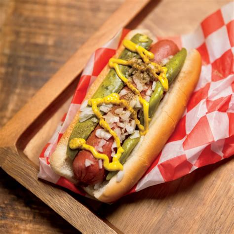 A Chicago Style Hot Dog is a steamed all beef Hot Dog topped with yellow mustard, bright green relish, onions, tomato wedges, pickle spear or slice, sport peppers and a dash of celery salt served in the all-important steamed poppy seed bun. The toppings are just as important as the order they are applied to the Hot Dog.. 