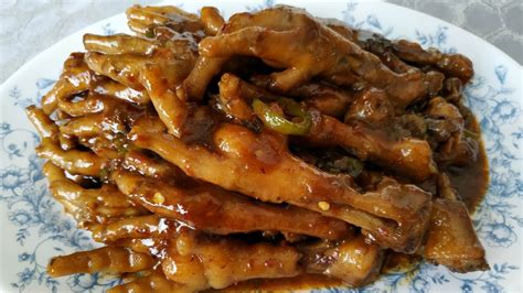In a large stock pot over medium-high heat, add in water, ginger, garlic, star anise, oyster sauce, chinkiang wine, and the deep fried chicken feet. Bring to a boil and stir. Lower the heat to medium-low or to a simmer and cover the pot. Simmer for about one hour.. 